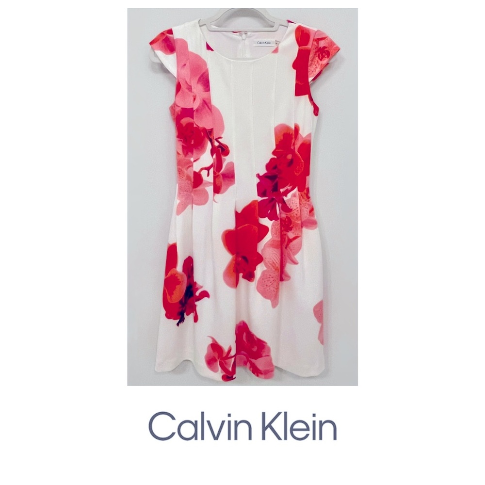 Calvin Klein a-line cap sleeve dress in coral-pink floral. Lined with pockets.